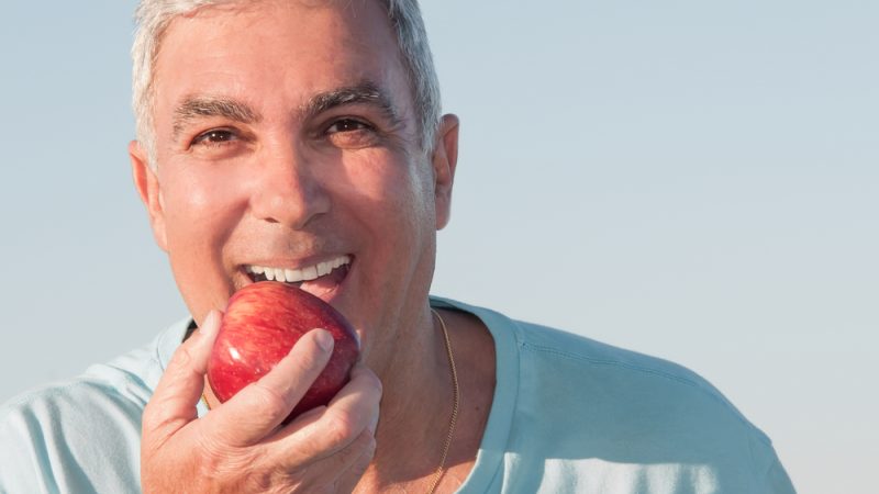 Portrait,Of,A,Mature,Man,About,To,Eat,A,Red